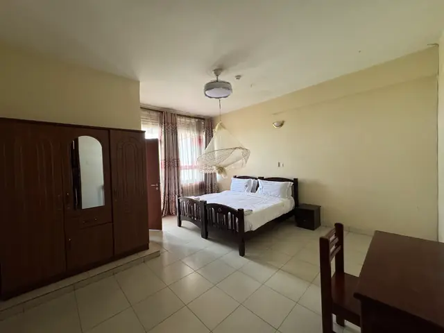 Double room seen from the doorway, with wardrobe, bed and window