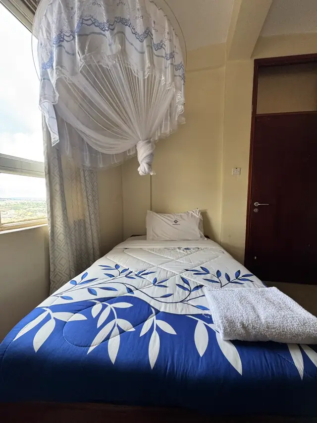 Executive Single Room: single bed beside a window with a view of the hills