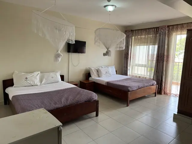 Executive Twin Room: twin beds beside full-height curtained windows